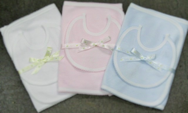Baby bibs in white, pink and blue with ribbon